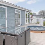 Private decking with sunken hot tubs at Florence Springs Luxury Lakeside Lodges - Tenby, Pembrokeshire, South Wales